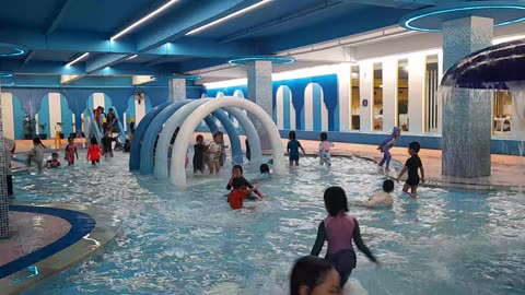 Happy Kids Swimming Together at Public Pool