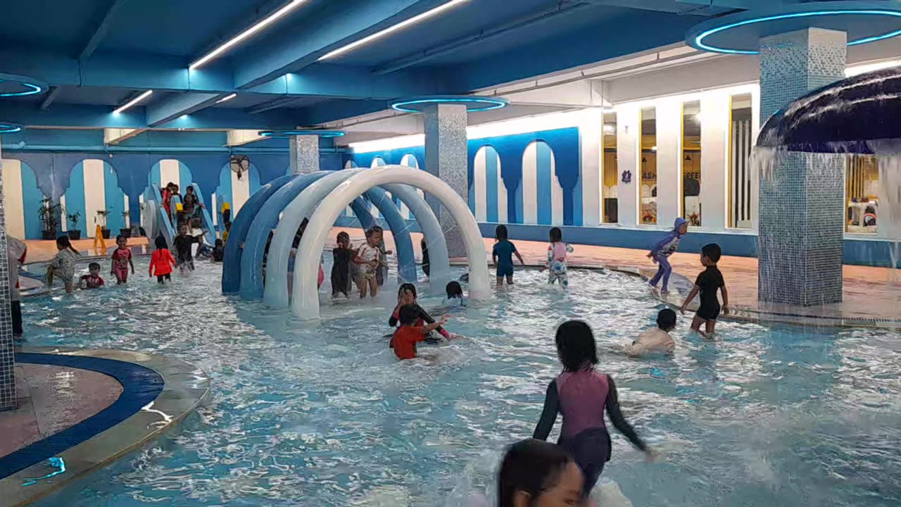 Happy Kids Swimming Together at Public Pool