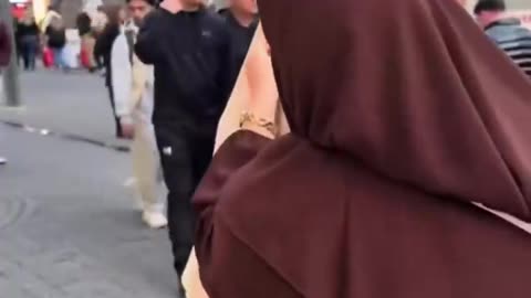 A Muslim influencer asking European women at Christmas markets to try on hijabs