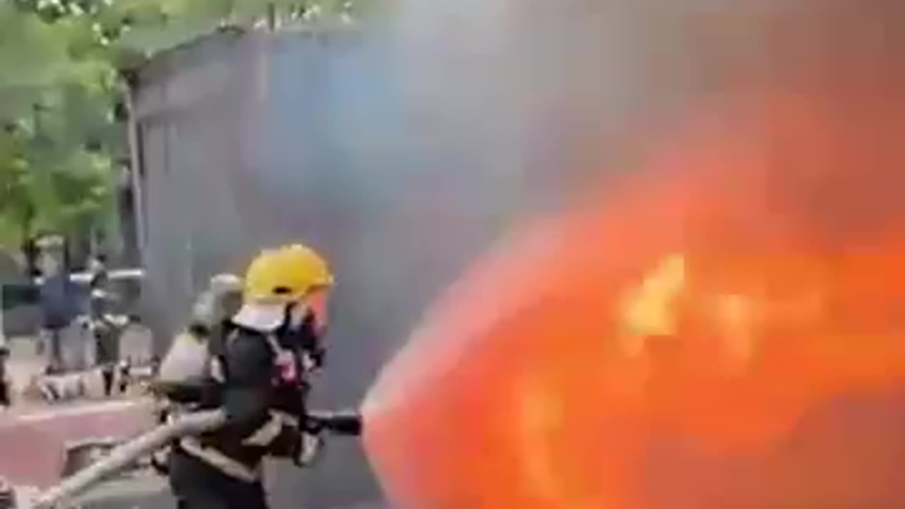 Firefighters use water shields to push back the blaze
