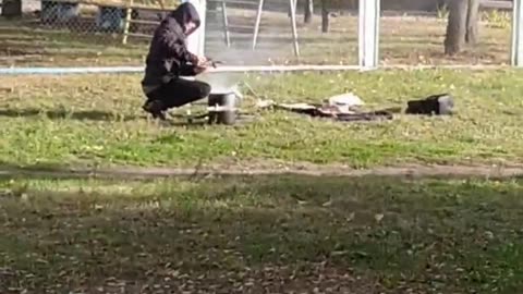 In Kyiv, a Man Cooks on an Open Fire — Just Like Before the Communists…