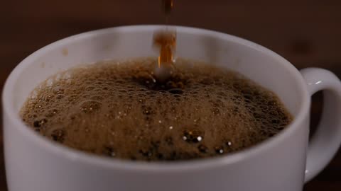 Pouring a Perfect Cup of Coffee into a White Mug