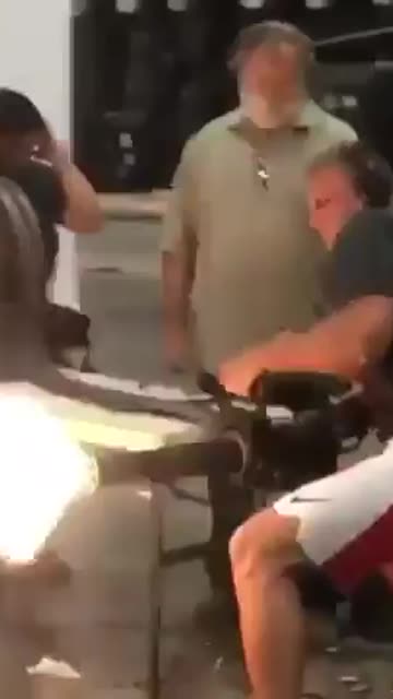 NFL Rob Gronkowski shooting a minigun.