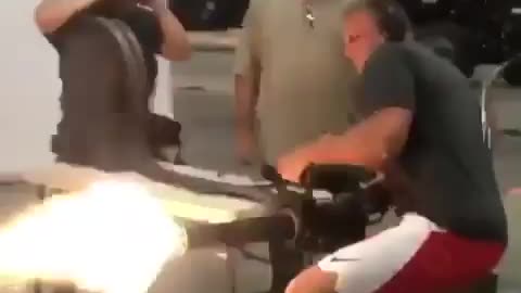 NFL Rob Gronkowski shooting a minigun.