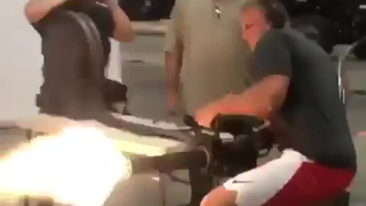 NFL Rob Gronkowski shooting a minigun.