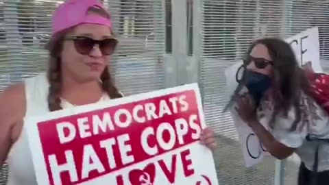 Woman shows her support for law enforcement in front of the ICE facility in Chicago.. 