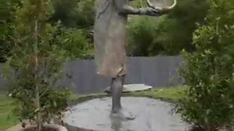 Human statue make a waterfall position