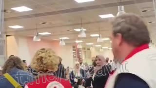 "Refugee" children arrive in Belgium. Complete with clothing depicting assault rifles on them.