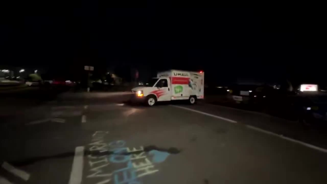 Another angle shows the moment law enforcement opened fire at a driver backing U-Haul