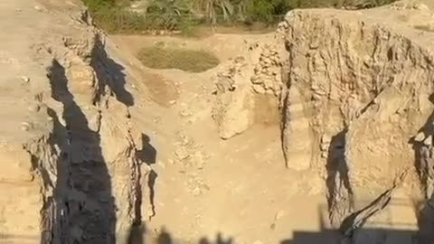A soldier blows a shofar at the walls of Jericho
