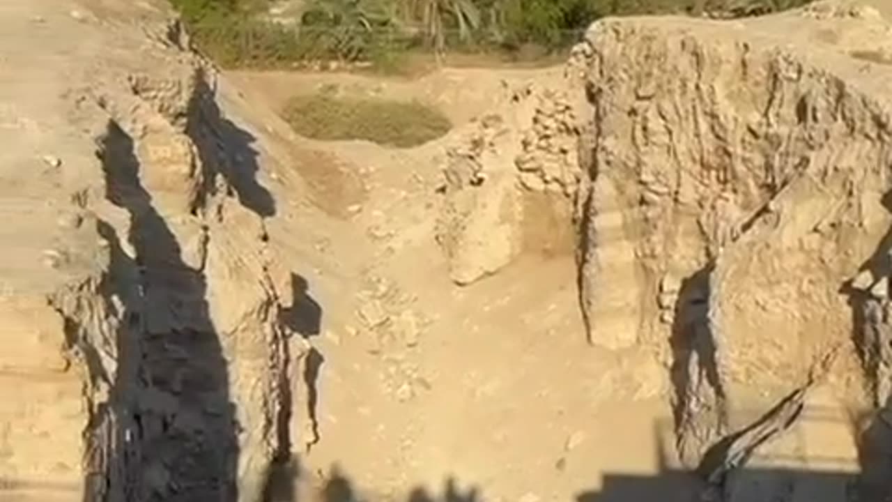 A soldier blows a shofar at the walls of Jericho