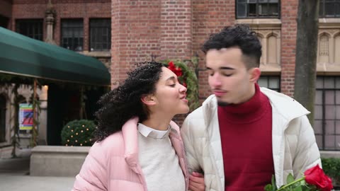 Young couple walking and kissing
