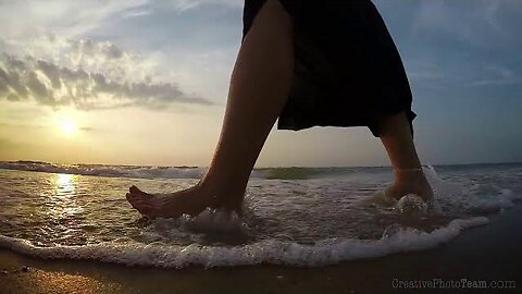 Barefoot legs of young female walking on the sunset beach, Biruchiy island,Ukraine PSN Experiment