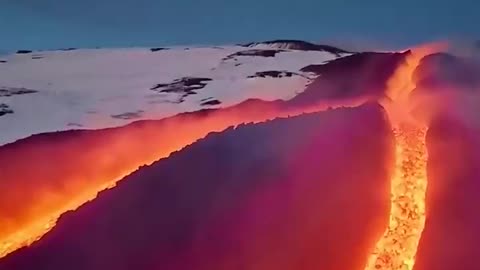 Molten lava flows down the slopes of Mount Etna in Sicily, Italy