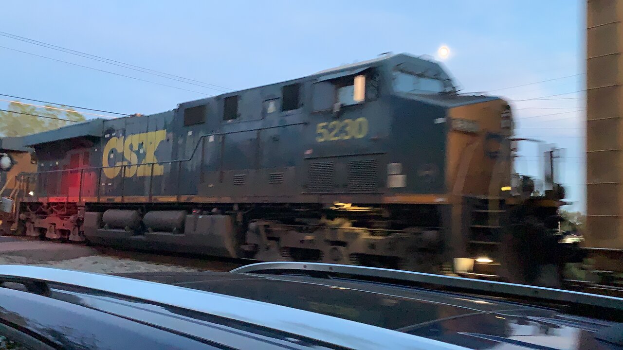 CSX Trains 714 and 5230 with traces of Amtrak behind it