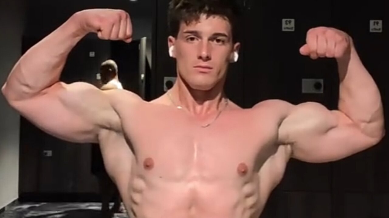 Handsome muscular man flexing big biceps