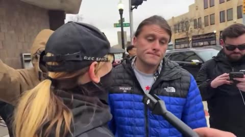 A White Male in an America First Hat holding a Cross was harassed by ANTIFA