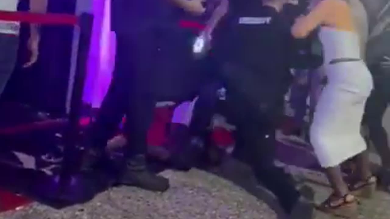 Woman spits in the face of a security guard.