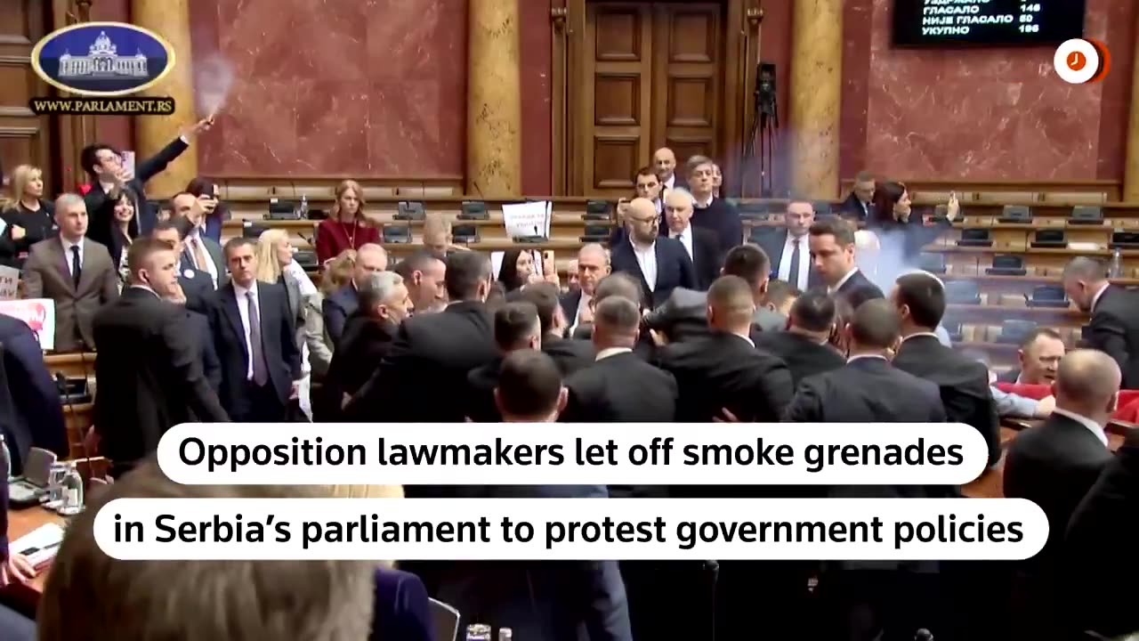 Serbian opposition deputies threw smoke grenades and tear gas inside parliament