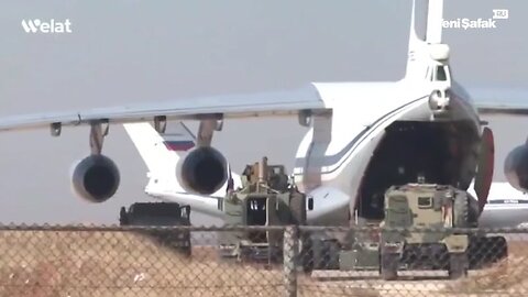 Russian planes are loaded with trucks and equipment at Qamishli airport in Syria