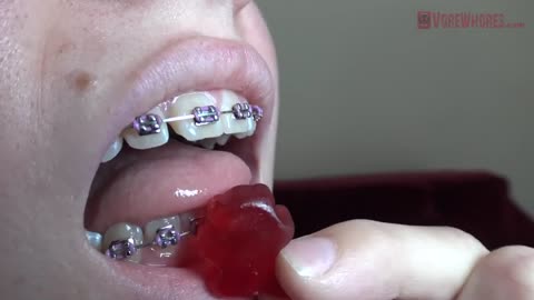 Giantess Vore - Giant blonde woman with braces swallows gummy bears