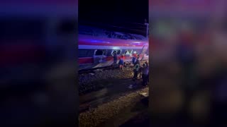 People escape from windows after two trains derail in Spain