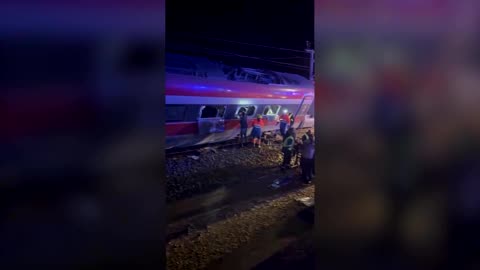 People escape from windows after two trains derail in Spain
