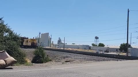 A CABOOSE AT THE LEAD AS UNION PACIFIC SWITCHER LEAVES STOCKTON YARD