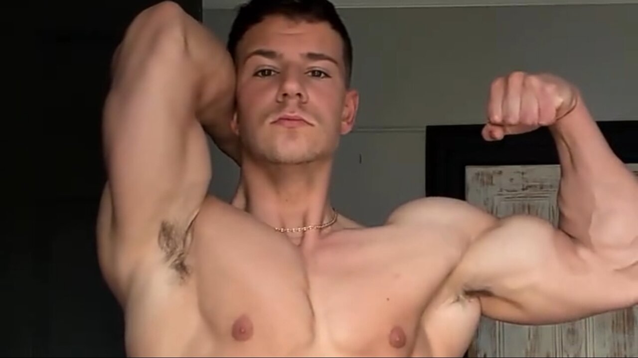 Young aesthetic bodybuilder flexing muscles