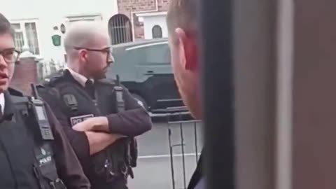 Four British officers go to a man's home to arrest him for his tweets 