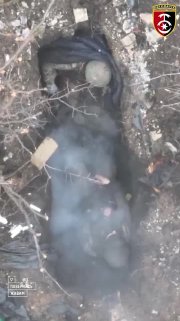 A Ukrainian drone dropping a grenade on two Russian soldiers 11 23 22