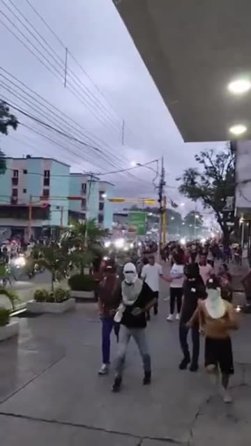 The statue of the dictator Hugo Chávez is dragged through the streets in Venezuela