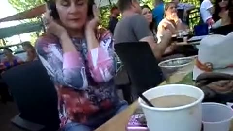 Showing elder woman my headphones at a concert while vacationing at a hotel