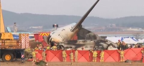 Rescuers pull people out of plane after fatal accident at a South Korean airport