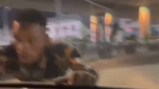 An African man climbs into a car with a woman driving because he wants a bribe