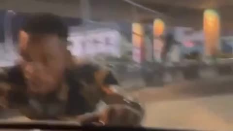 An African man climbs into a car with a woman driving because he wants a bribe