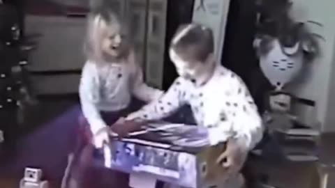 Young boy celebrates after getting a Nintendo 64 on Christmas morning in 1998