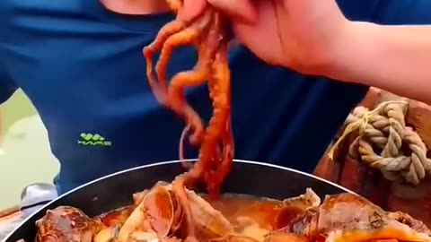 chinese fisherman cooking and eating fresh fish