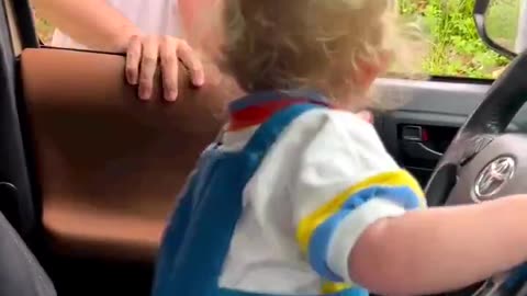 Dad pretends son is driving the truck. Kid's laugh is great!