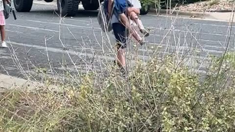Big Brother Carries His Little Sister Home