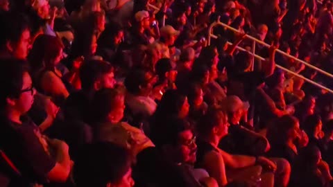 Fan Hangs Over Railing and Falls at Metal Concert