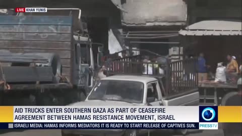 Hundreds of Palestinians rush toward the humanitarian aid trucks