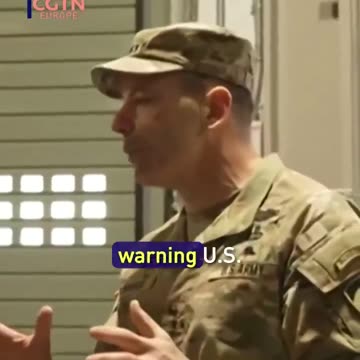 The new secretary of defense holding an energy weapon pistol...