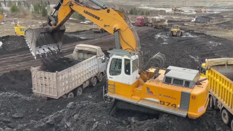 Liebherr 974 Excavator With the Help of the Cat 160H Graders Loading Truck