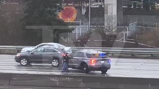 Seattle, WA: Man yanks female police officer out of her car, gets in, and drives off.