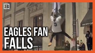 Eagles Fan Falls from Light Pole After Trying to Hang from Team Flag