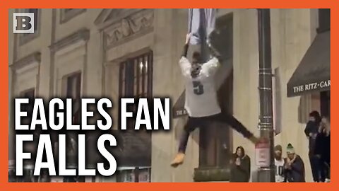 Eagles Fan Falls from Light Pole After Trying to Hang from Team Flag