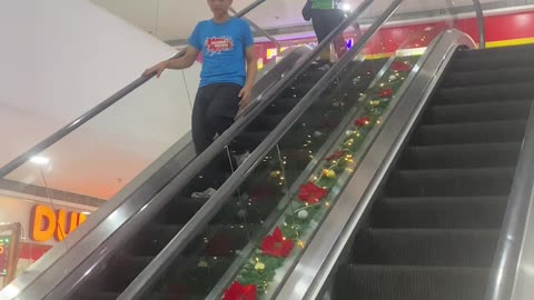Woman Distracted By Receipt Doesn't Move On Broken Escalator