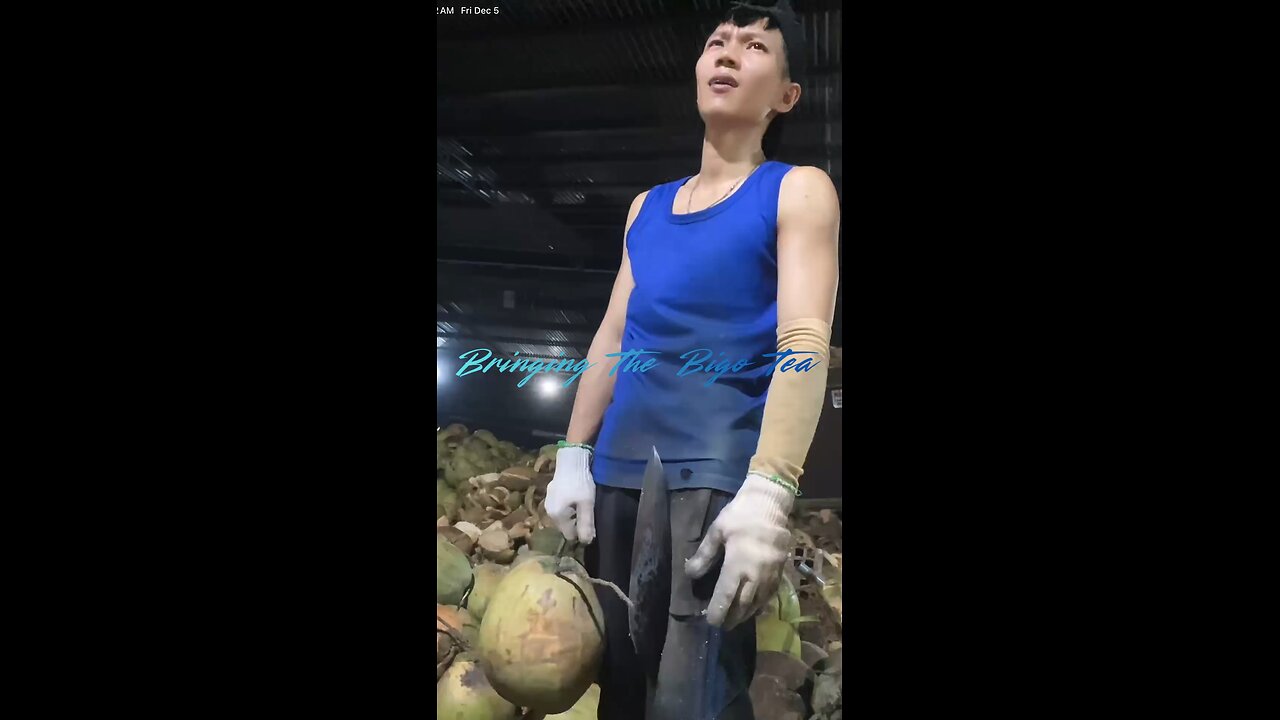 This guy from Vietnam is taking the outer layer off of coconuts.