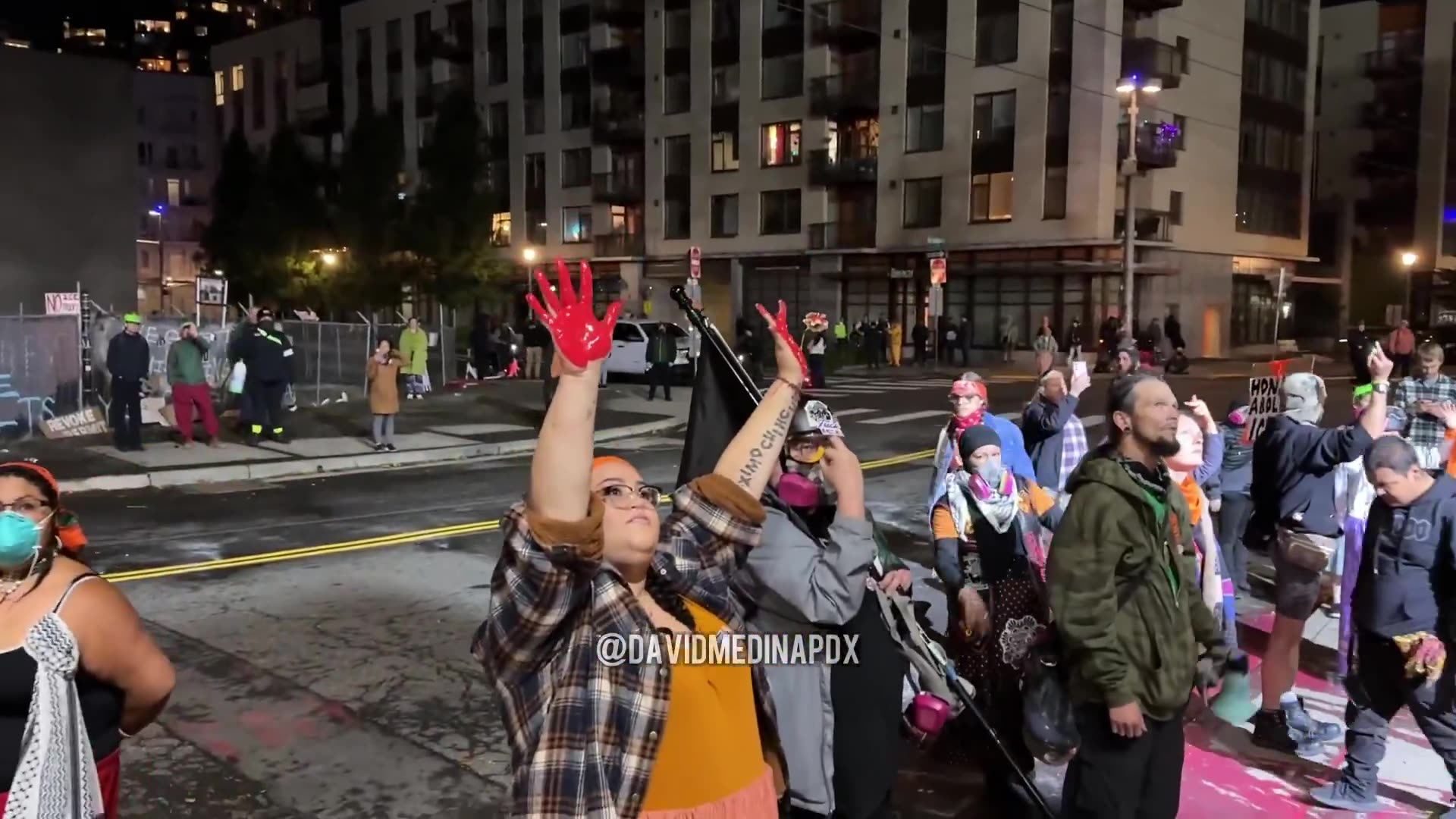 Anti-ICE Antifa protestors spill red paint on the driveway of the ICE building driveway and shout